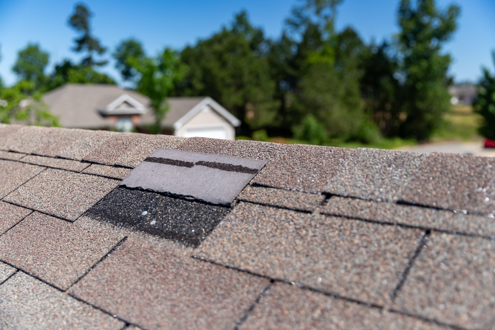 Roofing shingles damaged during a windy storm