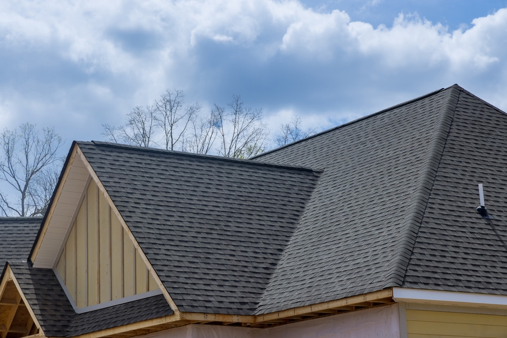 Asphalt shingles roofing for waterproofing on the covered corner of a new house under construction
